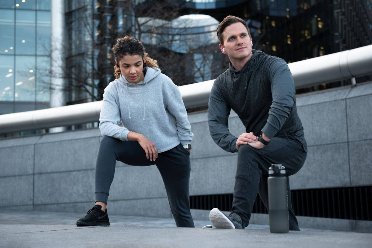 man and a women doing exercise while wearing the hoodie